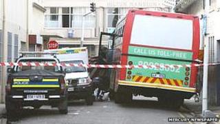 Police work the scene of the accident in Dick King Street in the Durban city centre. A teenage boy was killed when his head struck the sign attached to the street pole on the right