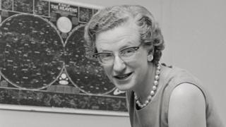 Dr. Nancy Grace Roman, chief of astronomy for NASA, is shown in her office