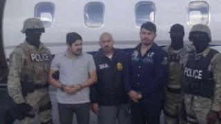 Efrain Campo and Francisco Flores with law enforcement officers