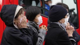 Local residents react as rescue workers carry out an operation at a collapsed house following an earthquake in Wajima, Ishikawa Prefecture, Japan, 05 January 2024.
