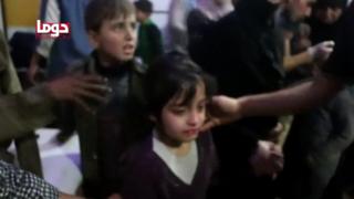 Children are given medical checks in what is said to be the rebel-held Syrian town of Douma, 7 April