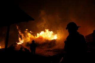 Firefighters try to stop the fire