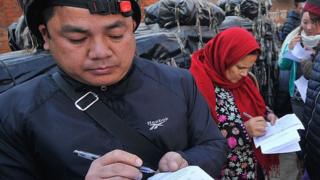 Nepalese people filling form exchange Indian currency at Nepal Rastra Bank