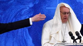 The wind catches the Pope's mozzetta as he recites the Angelus at the Knock shrine