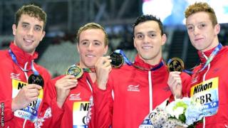 Britain's team members celebrate victory in the men's 4x200m freestyle relay