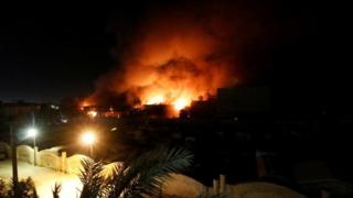 Flames emerge from the Council of Governors building in Basra