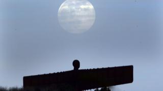 A pink supermoon is seen over the Angel of the North in Gateshead