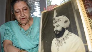 Amrit Kaur, the daughter of the late Maharaja of Faridkot- Harinder Singh Brar, poses with a portrait of the Maharaja at her residence in Chandigarh on August 2, 2013