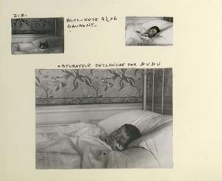 A family album page showing Lartigue sleeping in bed with a cat