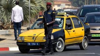 A Senegalese police officer stands guard outside a hotel in Dakar