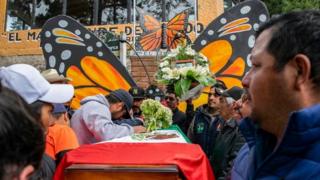 People mourn next to the coffin with the remains of environmentalist Homero Gomez