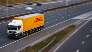 DHL lorry in motion on the motorway - stock photo