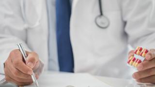 Doctor writing out a prescription