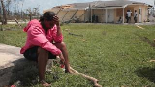 Una mujer sentada se toma la cabeza en Gran Ábaco.