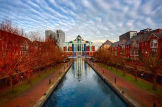 Trees and a building reflected in water