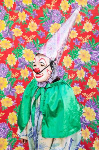 Portrait of clown in front of a patterned background