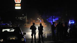 Two Mexican policemen at a scene of the shooting. File photo