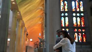 People embrace at the Sagrada Familia basilica in Barcelona, Spain, 4 July 2020