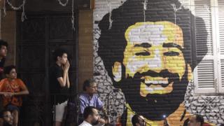 People watch the the UEFA Champions League final football match, between Real Madrid and Liverpool, at a coffee shop in the Egyptian capital Cairo on May 26, 2018