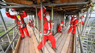 Santas erecting scaffolding around the Wellington Monument