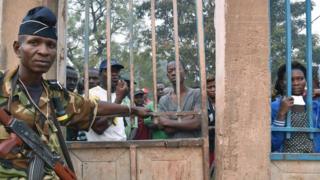 Voters wait oustide for the opening of polling stations in Bangui, on February 14, 2016