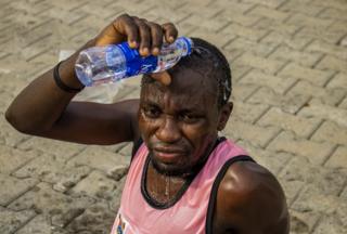 Man pouring water over his head