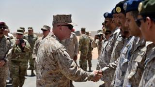 US Marine Corps Gen Kenneth McKenzie Jr shakes hands with Saudi military officers during his visit to a military base in al-Kharj in central Saudi Arabia on July 18, 2019