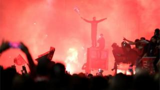 Fans celebrate outside Anfield