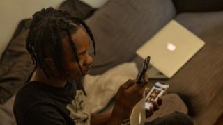 Naira Marley on im computer