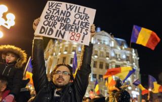 People hold placards during a protest rally in Timisoara, Romania, 03 February 2017.