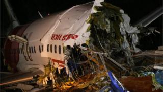 A view of the wreckage of the of an Air India Express Boeing 737 after it crashed at Calicut International Airport in Kozhikode, India, 08 August 2020. According to media reports, at least 17 people were killed after an Air India Express Boeing 737 en route from Dubai with 190 people on board skidded off the runway at Calicut International Airport during a landing amid rain and broke in two