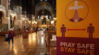 Inside Westminster Cathedral, with sign reading PRAY SAFE, STAY SAFE