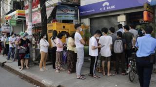 Myanmar people line up in front of a ATM machine of a closed bank in Yangon, Myanmar, 01 February 2021
