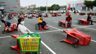 Shoppers sitting on trolleys in Durban, South Africa -Wednesday 1 April 2020