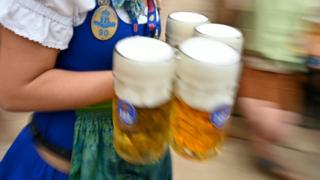 Waitress carrying beer at Oktoberfest in its opening weekend on 22 September 2019