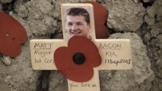 Cross for Matt Bacon with poppy and picture and the date of his death, 11 September 2005