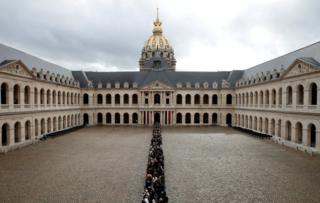 Visitors wait to view the coffin of former French President Jacques Chirac as it lies in state in the Invalides 29 September 2019. .