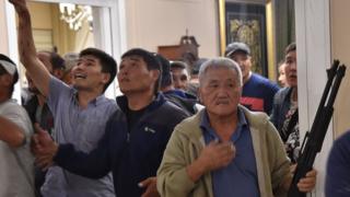 Supporters of former president Almazbek Atambayev guard his house as members of the special forces try to detain him outside the capital Bishkek on August 7, 2019
