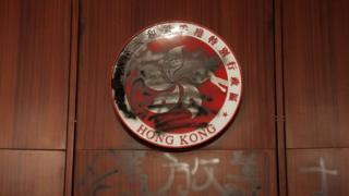 The Hong Kong emblem is spray painted
