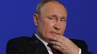 president putin with his hand to his chin looking concerned
