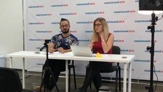 Lyubov Sobol (right) presents the news via her YouTube channel