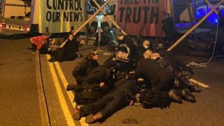 Protesters at a blockade near a printing press