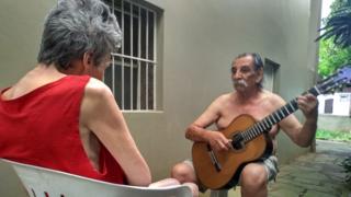 Lucio Yanel plays guitar to his wife Sueli