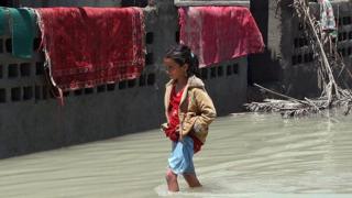 طفلة تمشي والمياه تقترب من ركبتيها
