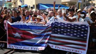 Hundreds of Cubans and visitors from other countries gather at the newly reopened U.S. Embassy in Cuba