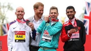 Derek Rae on the London Marathon podium with Australia's Michael Roeger and Morocco's El Harti, joined by the Duke of Sussex