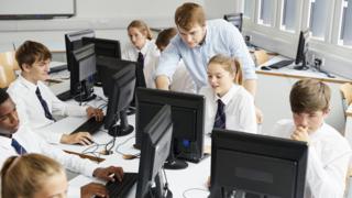 Teacher teaching children IT