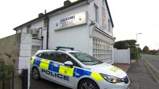 Police car outside Gandhi restaurant