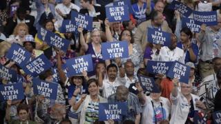 Delegates hold up signs in support of Hillary Clinton on Day 1 of the Democratic National Convention