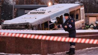 Rescuers pull out a city bus after it ploughed into a pedestrian underpass in western Moscow on December 25, 2017
